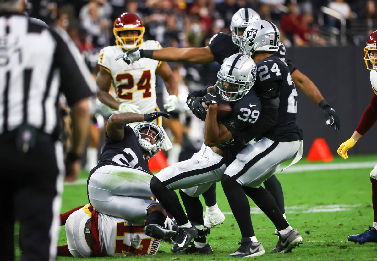Raiders cornerback Nate Hobbs (39) intercepts the ball against Washington Football Team during ...