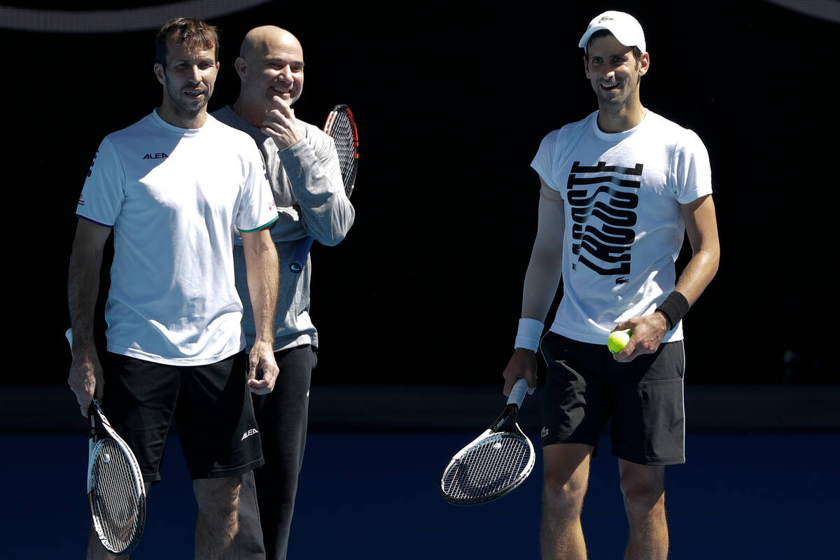 FILE - In this Jan. 14, 2018, file photo, Serbia's Novak Djokovic, right, talks with his coache ...