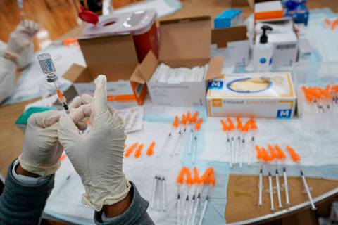 FILE - In this April 8, 2021, file photo, a Northwell Health registered nurses fills a syringe ...