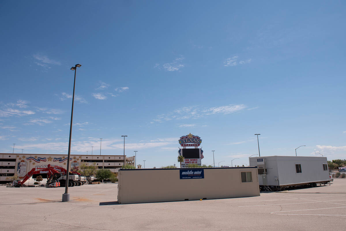 Heavy machinery and construction trailers are staged in the parking lot of the Texas Station ho ...