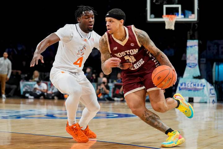 Boston College's Brevin Galloway (51) drives against Miami's Bensley Joseph (4) in the first ha ...