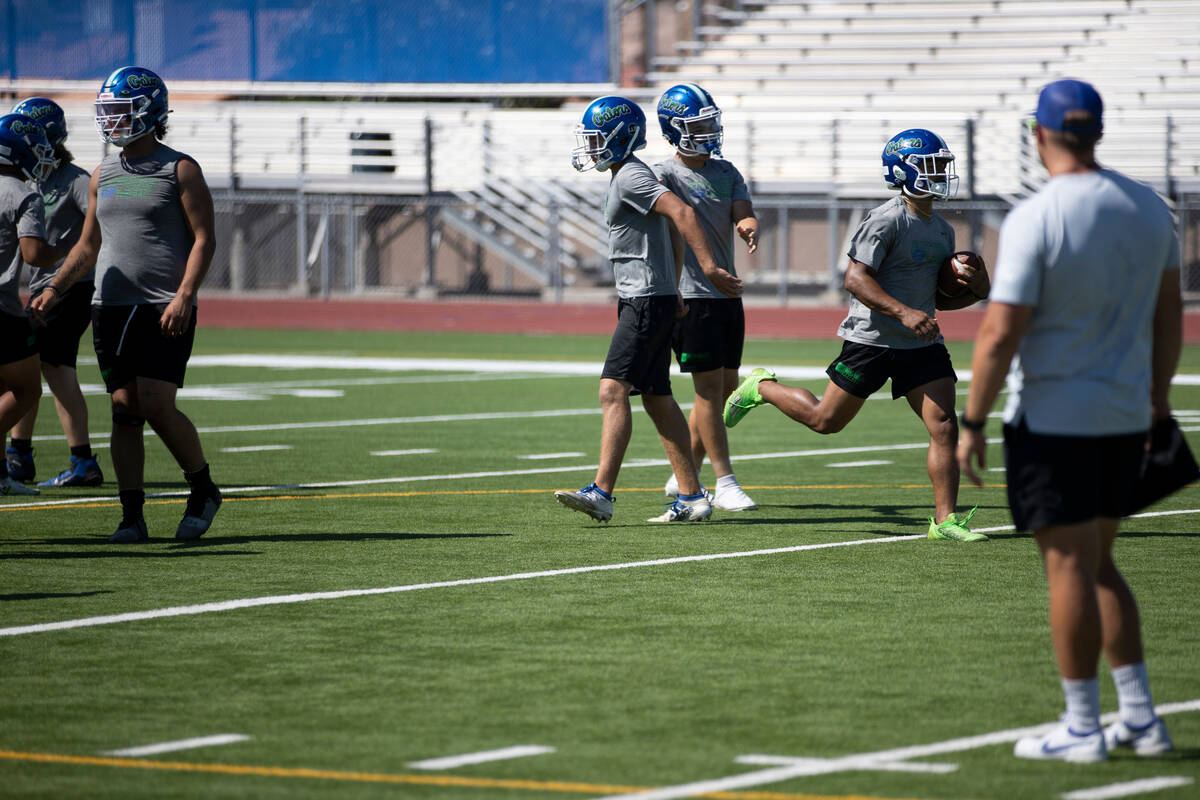 Players participate during a team football practice at Green Valley High School in Henderson, T ...