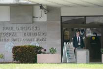 A security guard stands outside the Paul G. Rogers Federal Building and U.S. Courthouse, Thursd ...