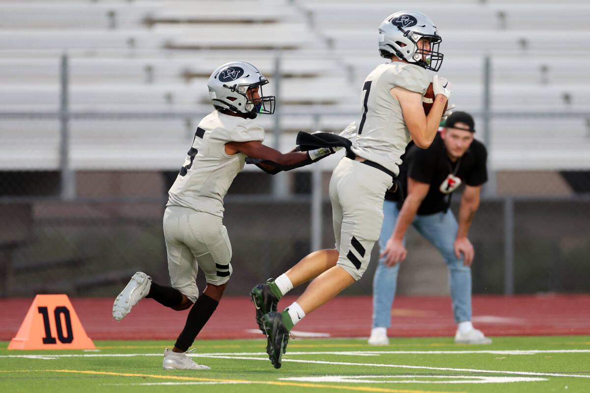 Palo Verde's Jace Neely (7) makes an interception as Omari Jones (5) looks on during the first ...