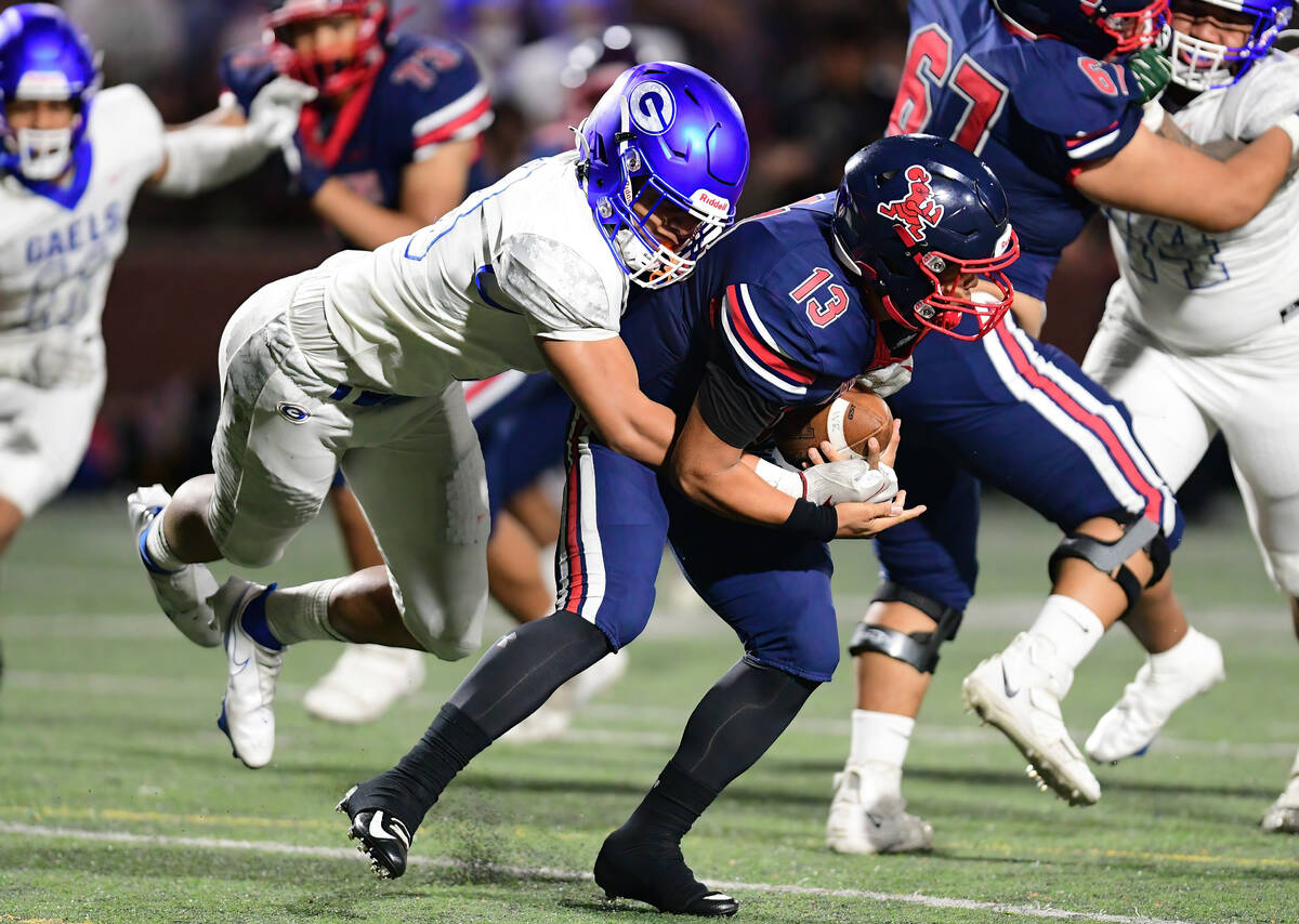 Bishop Gorman linebacker Jonah Leaea (18) made a tackle during a game between the Bishop Gorman ...