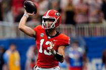 Georgia quarterback Stetson Bennett (13) throws on the run in the first half of an NCAA college ...