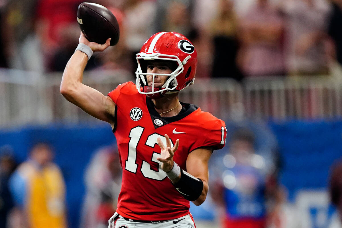 Georgia quarterback Stetson Bennett (13) throws on the run in the first half of an NCAA college ...