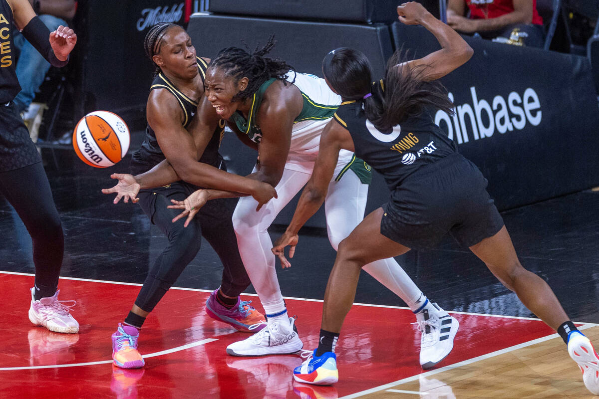 Las Vegas Aces guard Chelsea Gray (12) fouls Seattle Storm center Tina Charles (31) with Las Ve ...