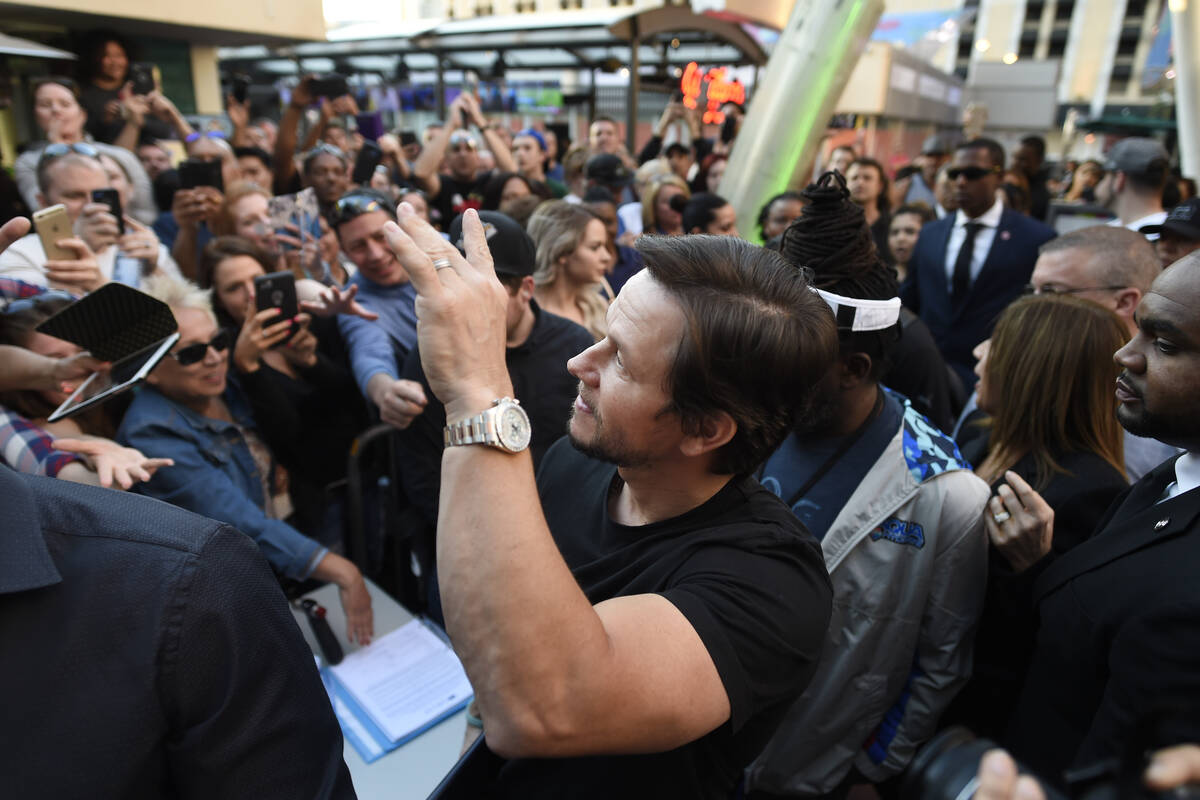 Mark Wahlberg waves to fans as he arrives at a VIP event at Wahlburgers Las Vegas in the Grand ...