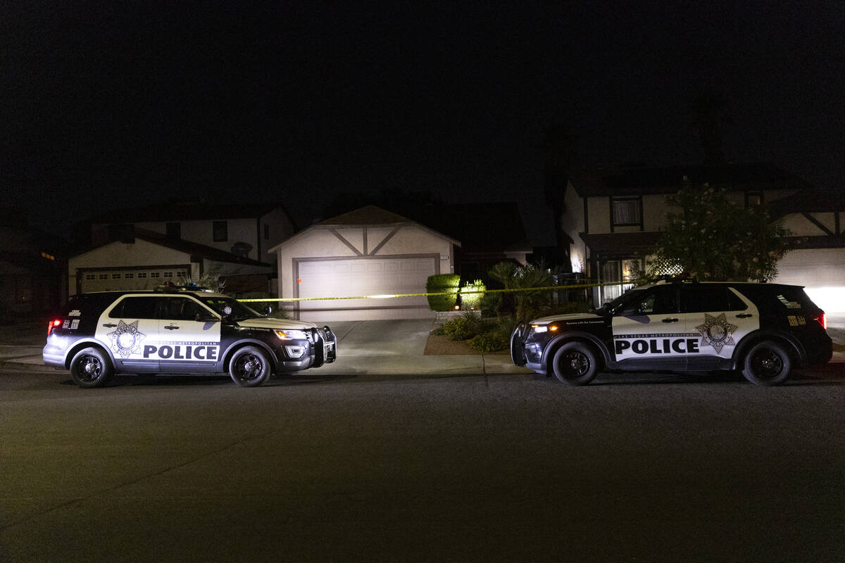 Las Vegas police monitor a homicide scene at the 7200 block of Bronze Circle in Las Vegas, Satu ...