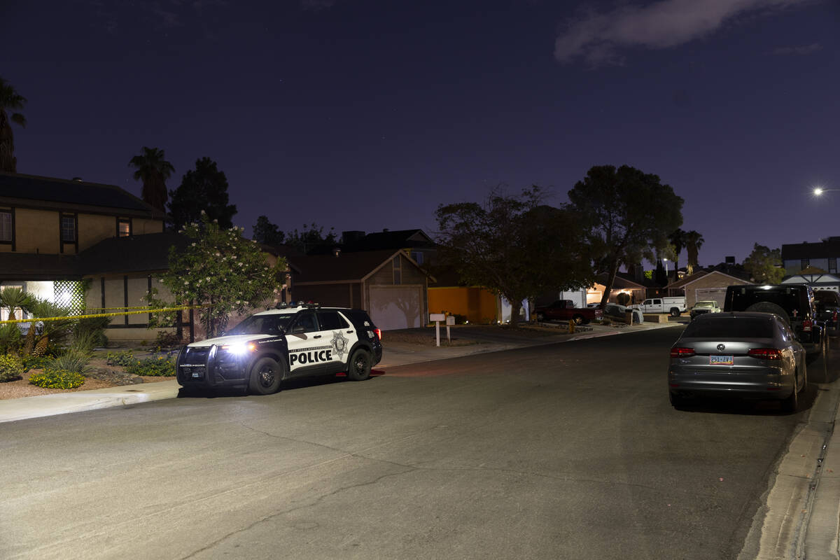 Las Vegas police monitor a homicide scene at the 7200 block of Bronze Circle in Las Vegas, Satu ...