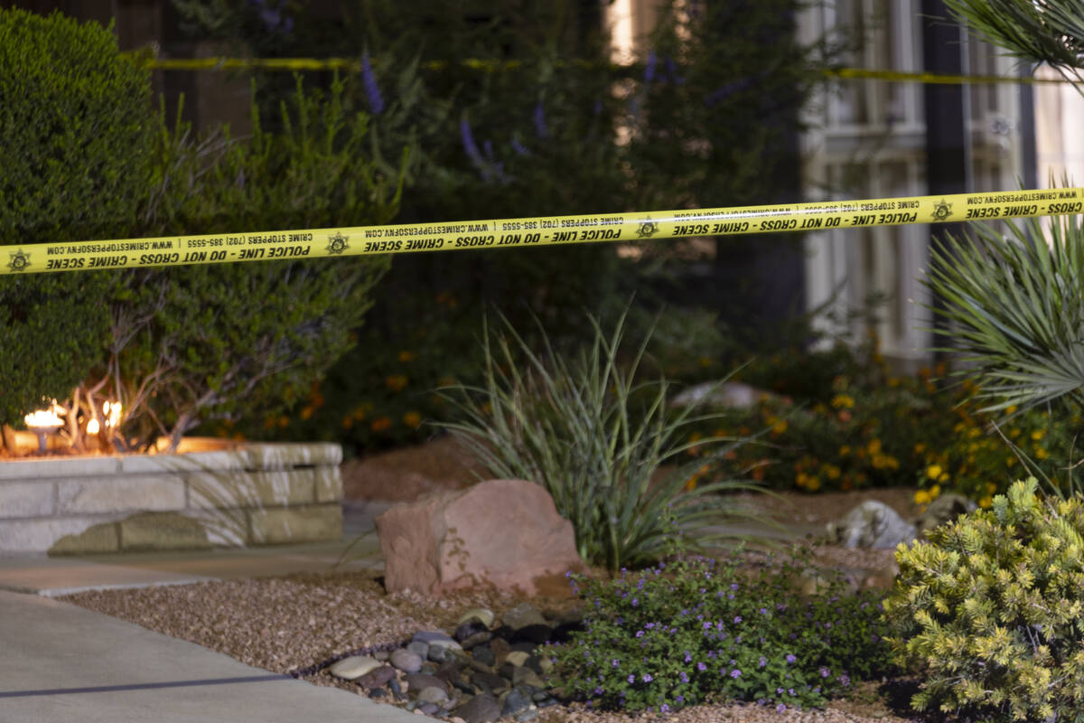 Las Vegas police monitor a homicide scene at the 7200 block of Bronze Circle in Las Vegas, Satu ...