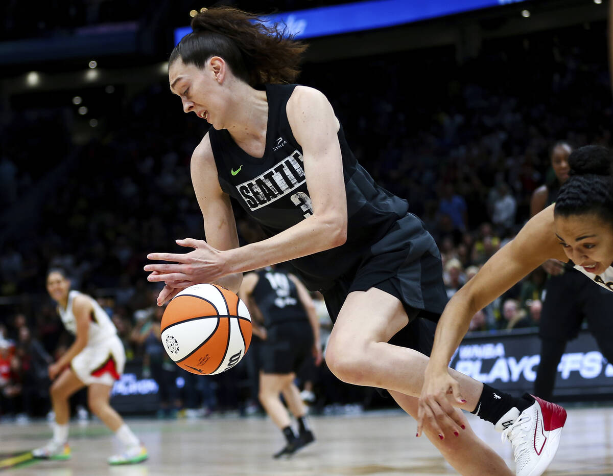 Seattle Storm forward Breanna Stewart, left, grabs the ball away from Las Vegas Aces center Kia ...