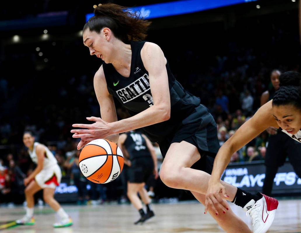 Seattle Storm forward Breanna Stewart, left, grabs the ball away from Las Vegas Aces center Kia ...