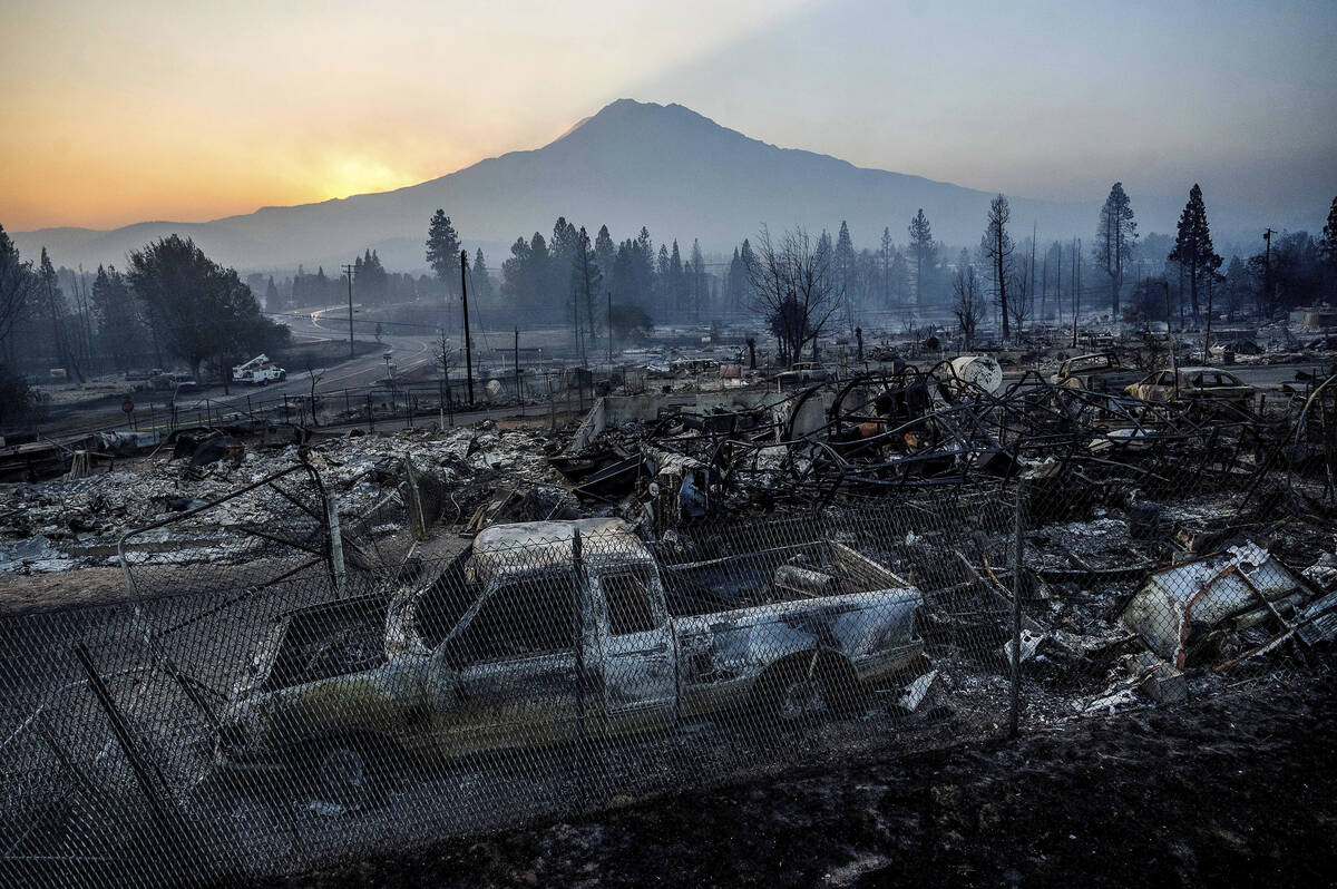 The sun rises over Mt. Shasta and homes destroyed by the Mill Fire on Saturday, Sept. 3, 2022, ...