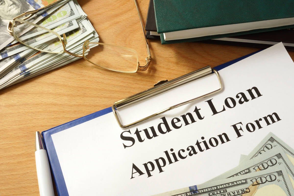 Student loan form with dollars and books.