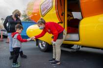 Niener Wiener, right, hands Brenden McCormack, 3, a sticker as he and aunt Corinne Weidman visi ...