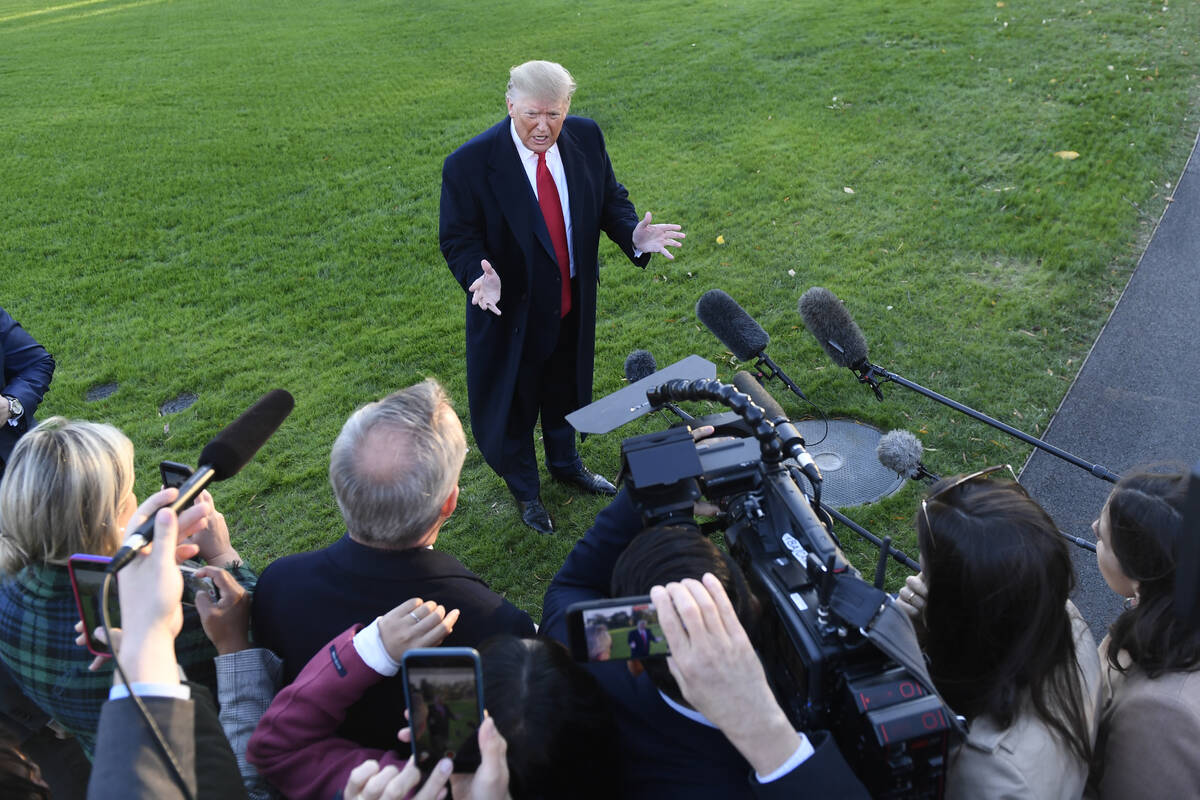 President Donald Trump talks to reporters on the South Lawn of the White House in Washington in ...