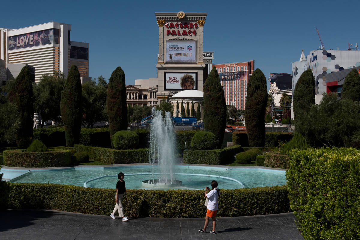 Suin Moon, left, and Meen Kim, of Los Angeles, take photos in front of a fountain near Caesars ...