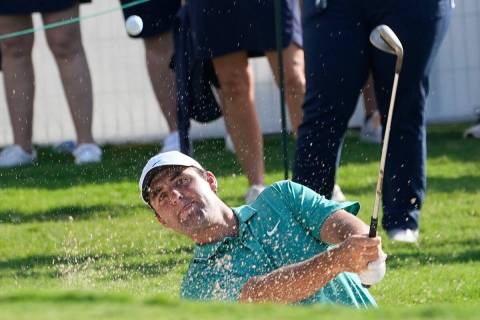 Scottie Scheffler hits the ball from a bunker near the 18th green during the final round of the ...