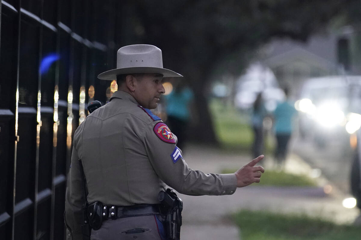 A Texas State Trooper stands watch as students are dropped off at Uvalde Elementary for the fir ...