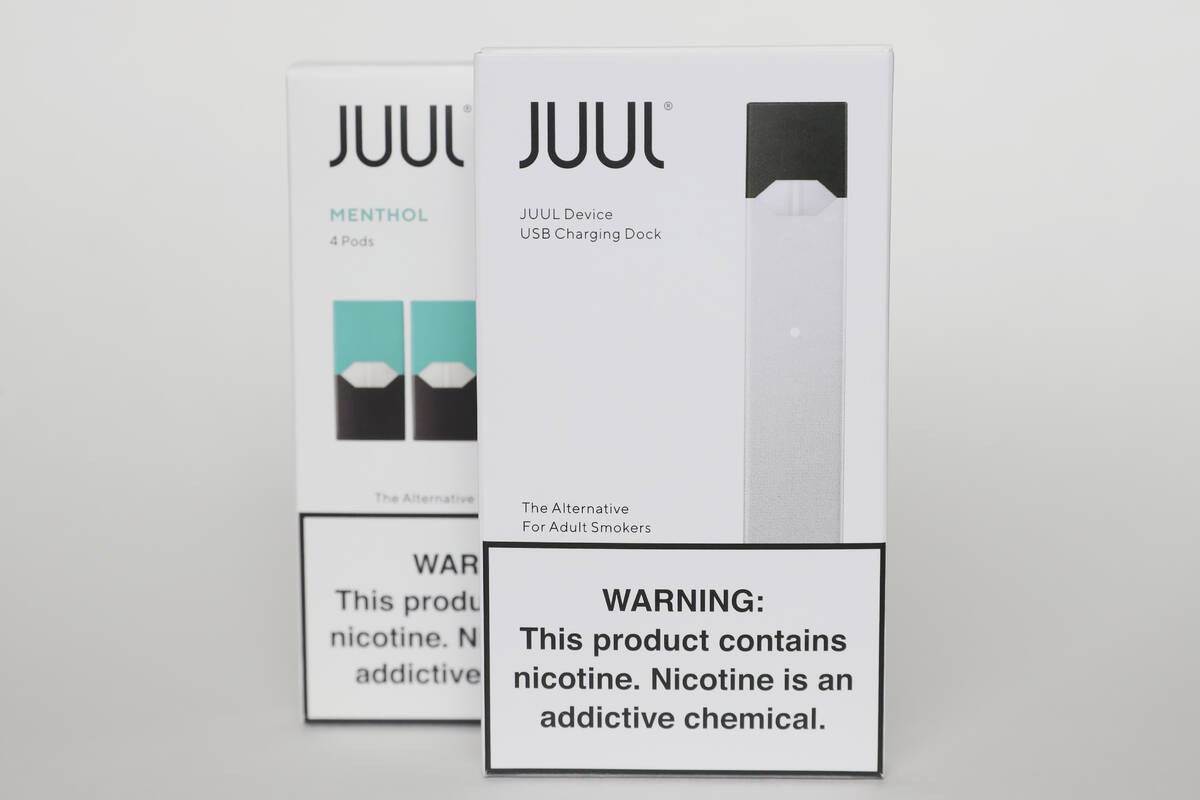 FILE - Packaging for an electronic cigarette and menthol pods from Juul Labs is displayed on Fe ...