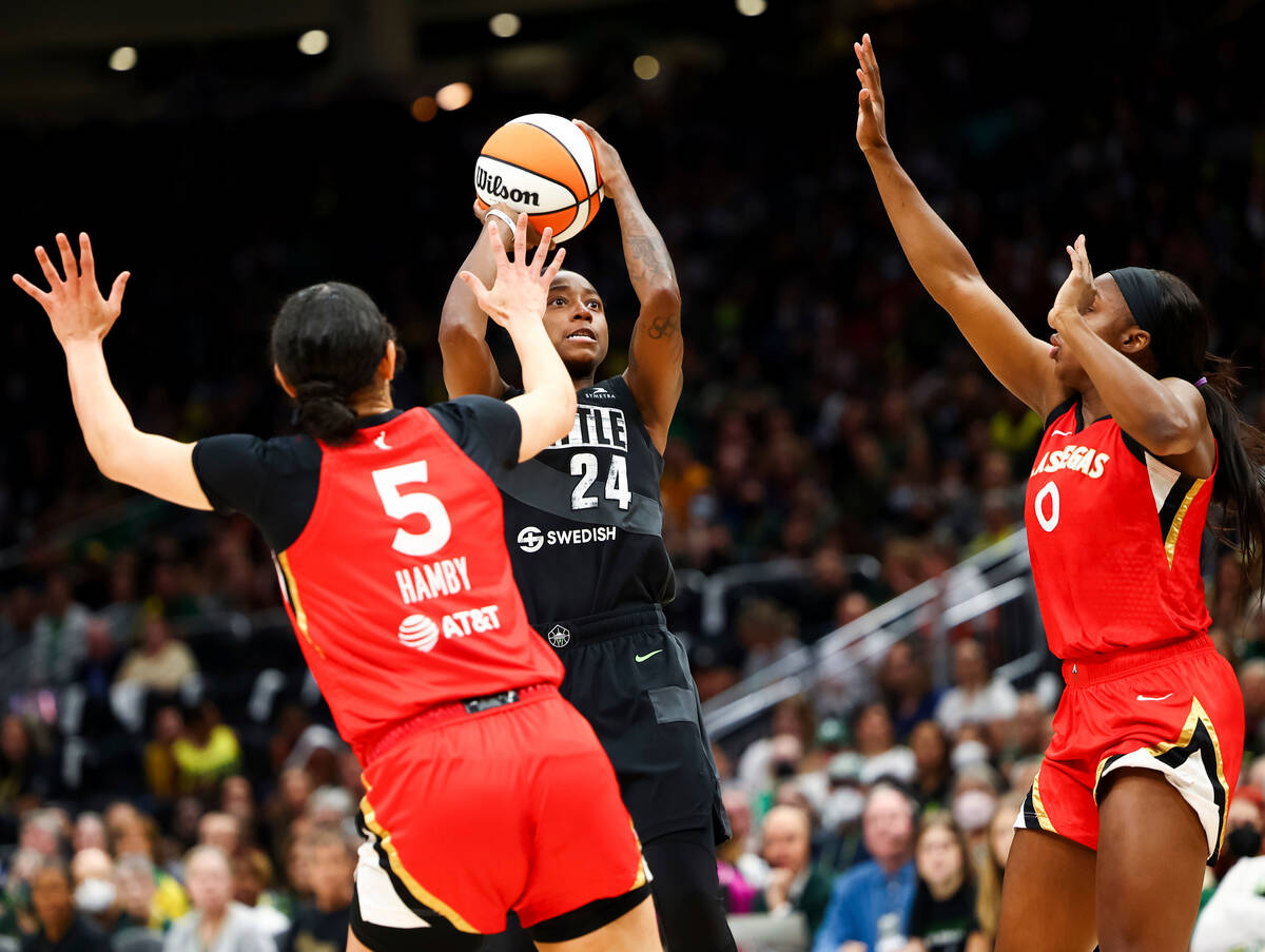 Seattle Storm guard Jewell Loyd (24) shoots between the defense of Las Vegas Aces forward Deari ...
