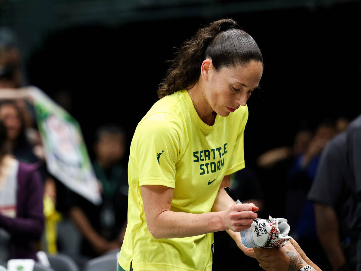 Seattle Storm guard Sue Bird signs a "Keep Sue Fresh" shoe before Game 4 of the team' ...
