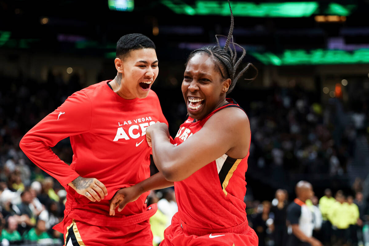 Las Vegas Aces guard Chelsea Gray, right, celebrates with guard Kierstan Bell at the end of the ...