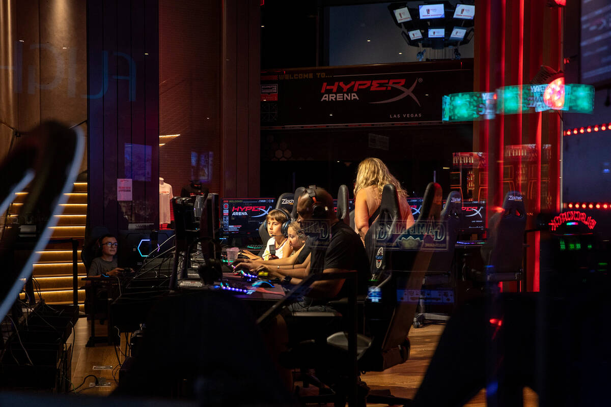 Gamers play in the public section of HyperX Arena Las Vegas while a UNLV panel on the esports e ...