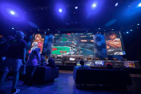 People watch a weekly tournament called "Knockdown" of fighting games, Friday, Sept. ...