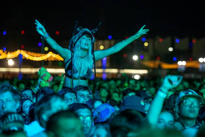 Fans listen while bathed in blue as Modest Mouse performs on the Downtown Stage during day two ...