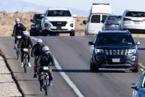 Cyclists ride their bike along the Charleston Blvd near Red Rock, on Tuesday, Dec. 29, 2020, in ...