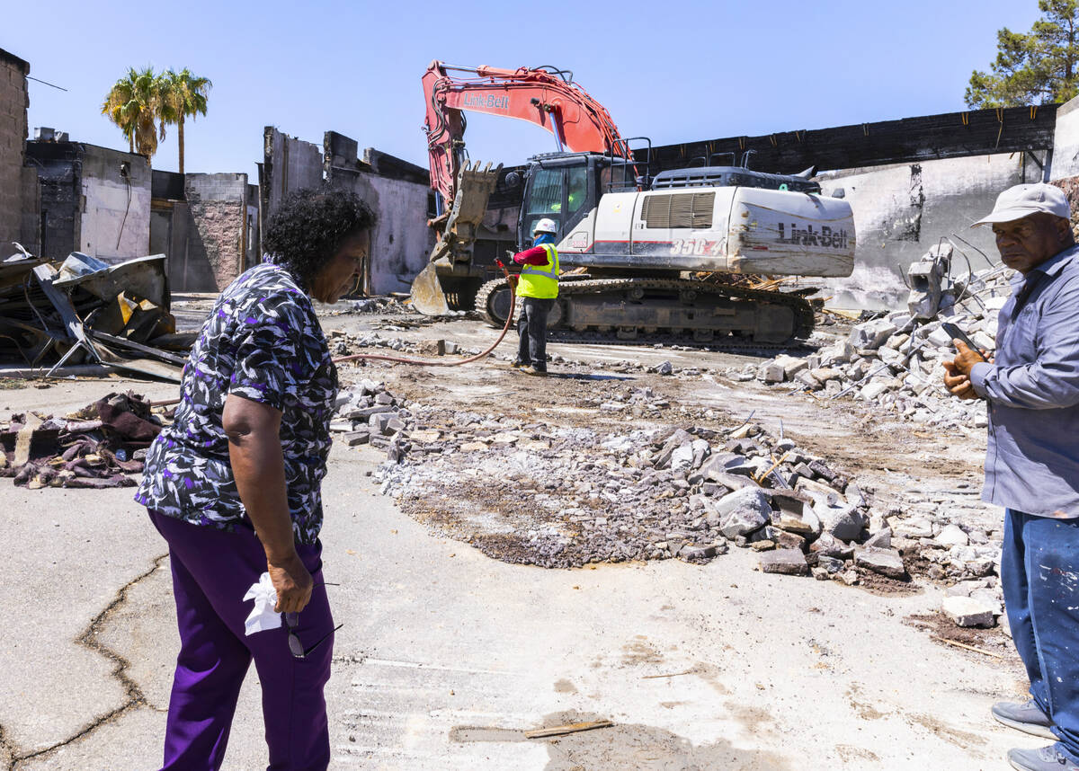 Linda Stanley, left, pastor at Zion United Methodist Church, watches as demolition crews tear d ...