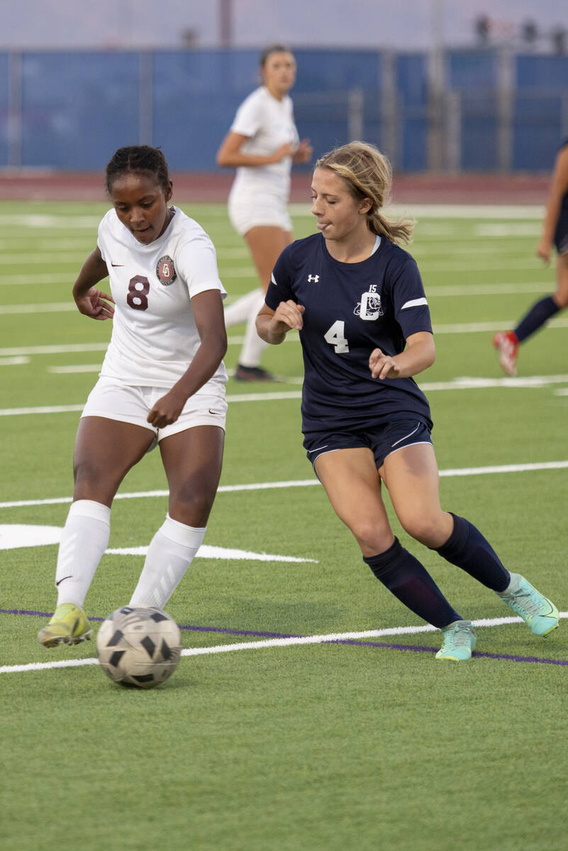 Desert Oasis junior Lillian Felise (8) gets around Centennial junior Chanel Cave (4) during the ...