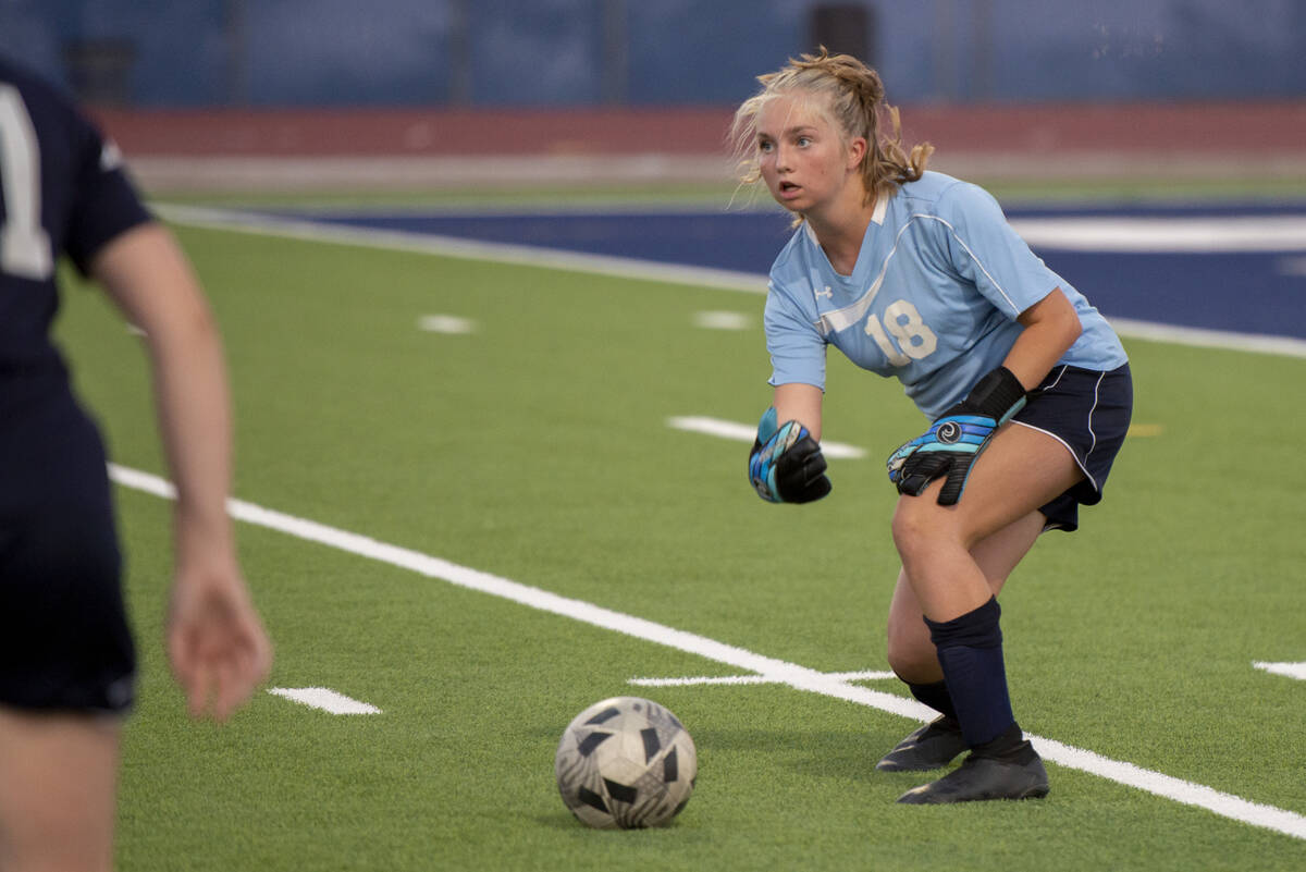 Centennial High School goalie Ellie Church (18) plays the ball to a teammate during their game ...