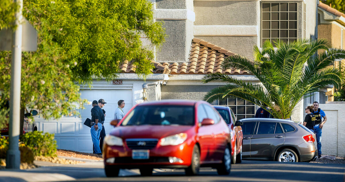 Las Vegas police officers and homicide detectives near the home of Robert Telles on the 9600 bl ...