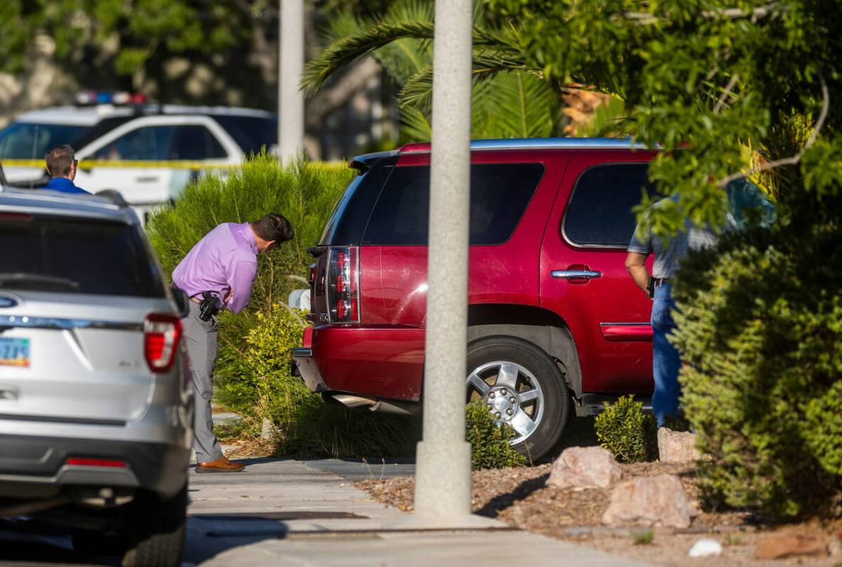 Las Vegas police homicide detectives inspect a vehicle at the home of Robert Telles on the 9600 ...