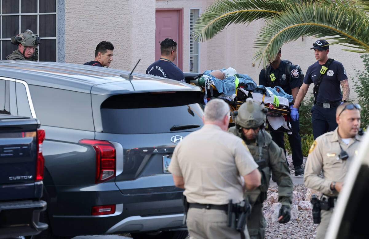 Las Vegas police and emergency personnel escort Clark County Public Administrator Robert Telles ...