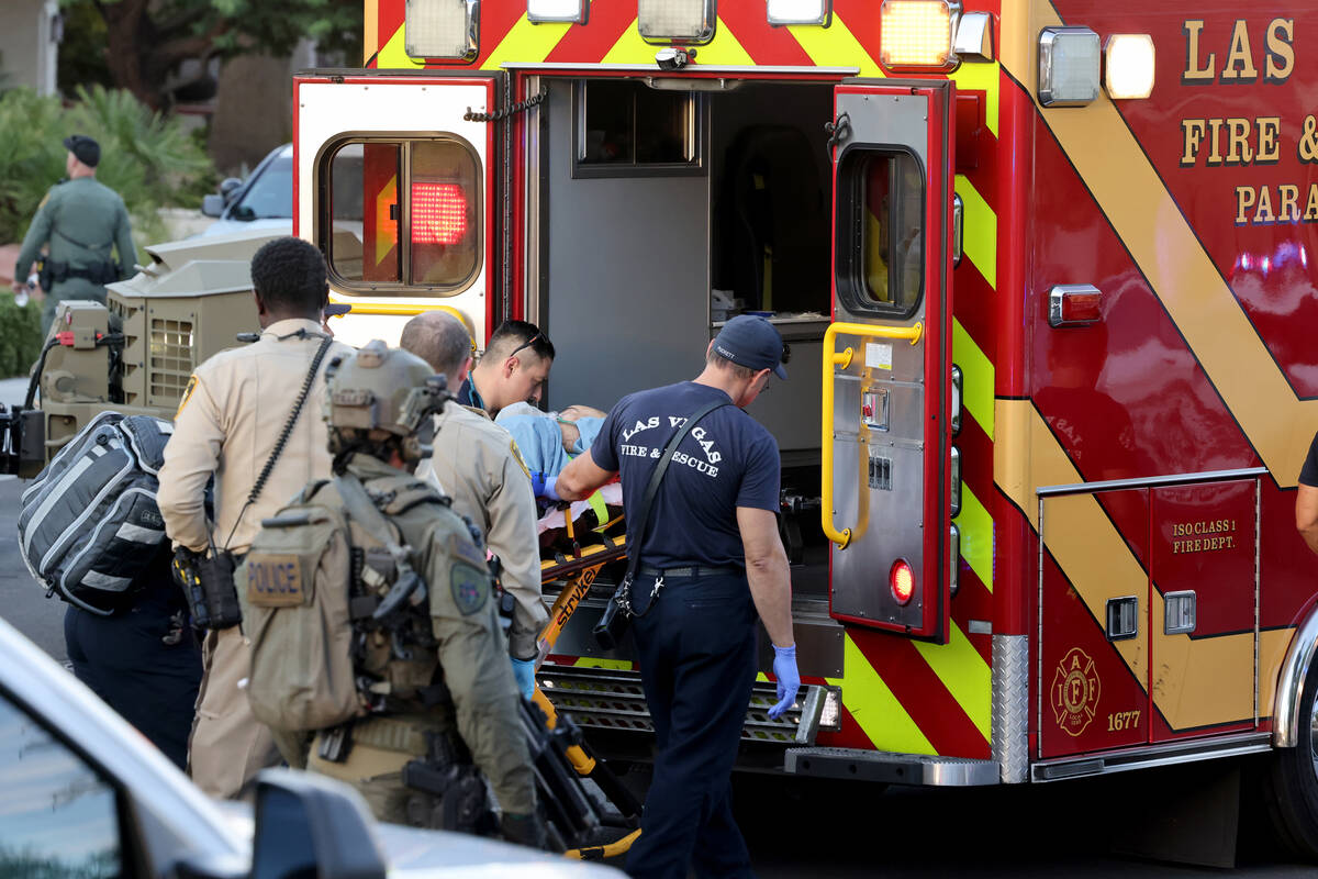 Las Vegas police and emergency personnel escort Clark County Public Administrator Robert Telles ...