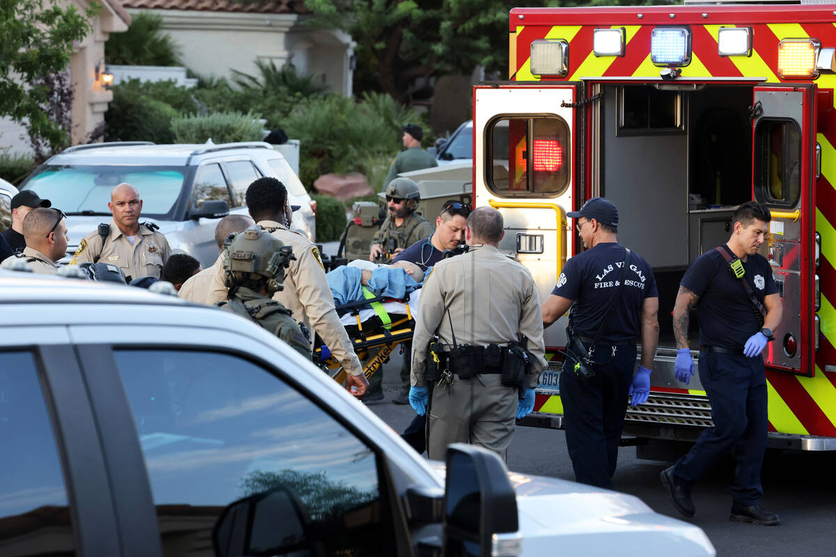 Las Vegas police and emergency personnel escort Clark County Public Administrator Robert Telles ...