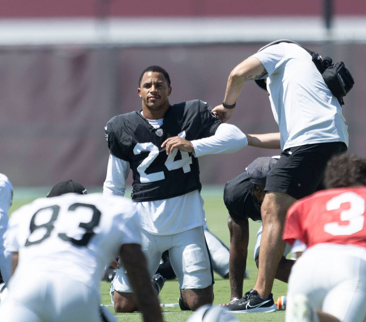 Raiders safety Johnathan Abram (24) gets a uniform adjustment as he stretches during practice a ...