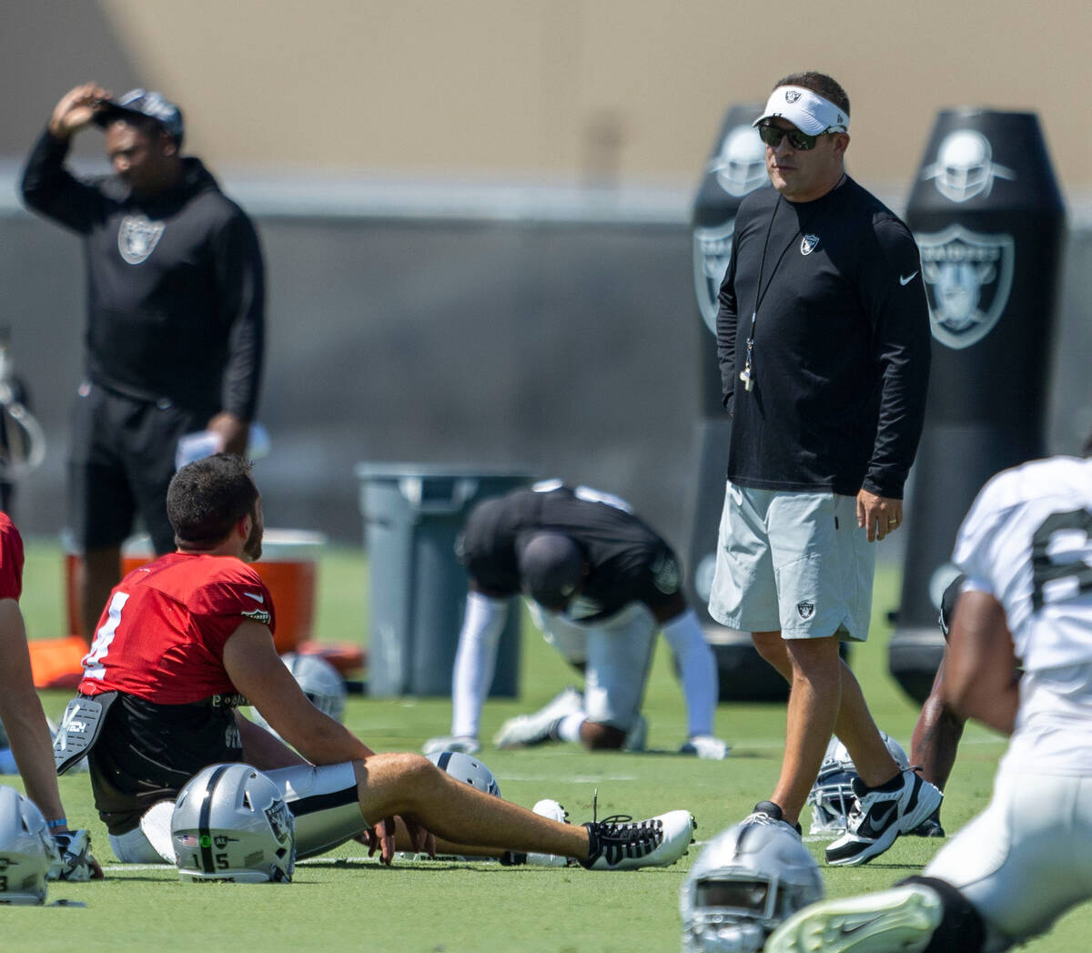 Raiders quarterback Derek Carr (4) speaks to head coach Josh McDaniels during practice at the I ...