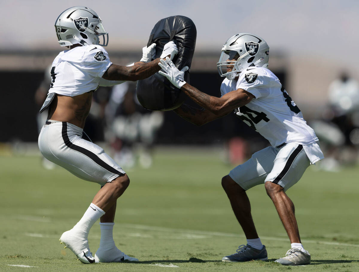 Raiders wide receivers Tyron Johnson (1) and Keelan Cole (84) work a drill during practice at t ...