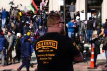 FILE - A man wearing an Oath Keepers shirt stands outside the Kenosha County Courthouse, Nov. 1 ...
