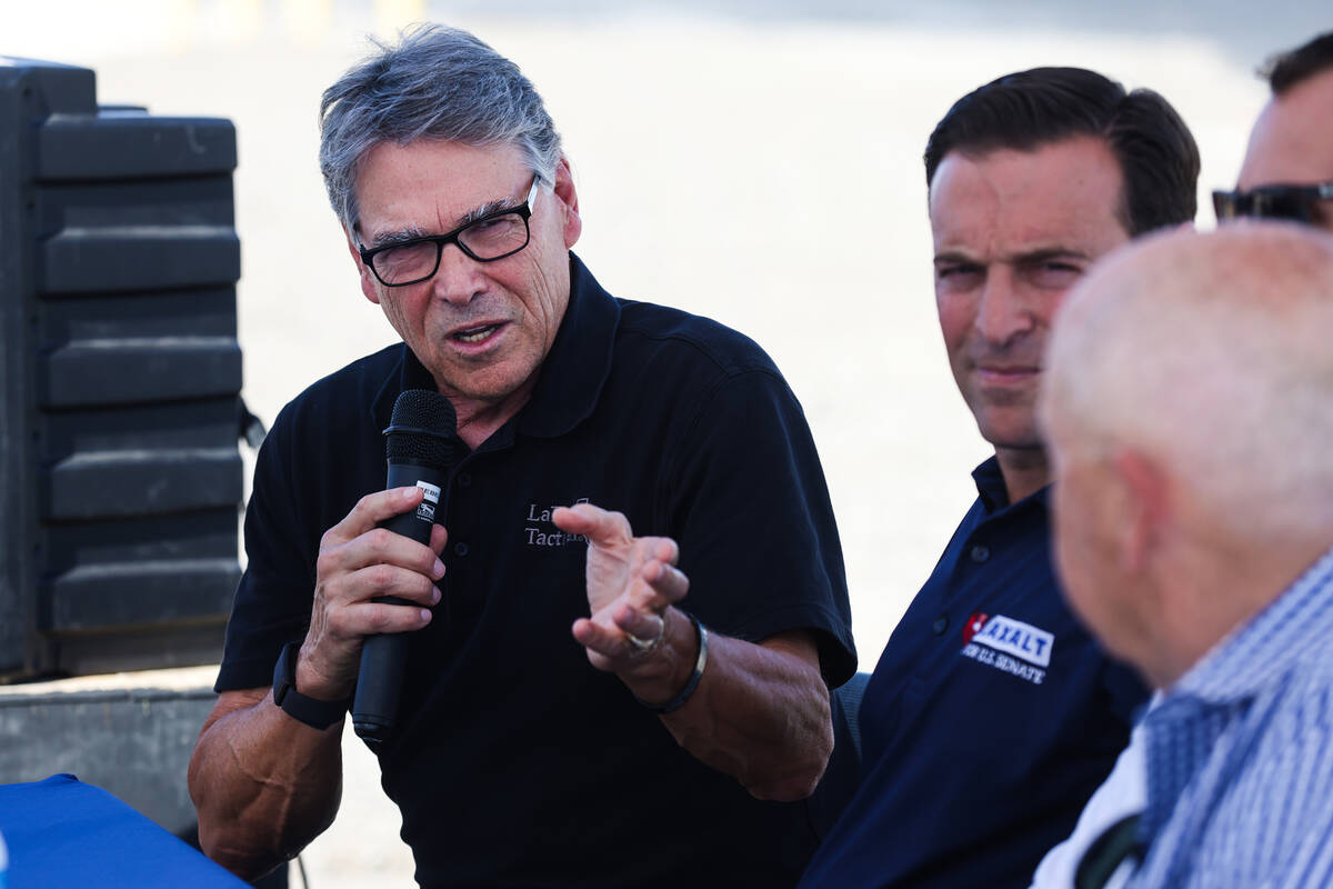 Former Texas Gov. Rick Perry speaks next to U.S. Senate candidate Adam Laxalt at a panel discus ...