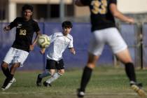 Cimarron-Memorial’s Miguel Pina, center, passes to a teammate while Durango’s Don ...