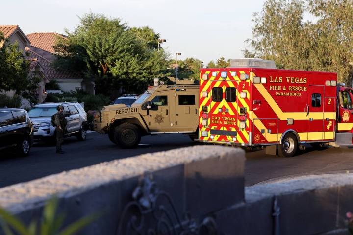 A SWAT vehicle and Las Vegas Fire and Rescue ambulance outside the home of Clark County Public ...