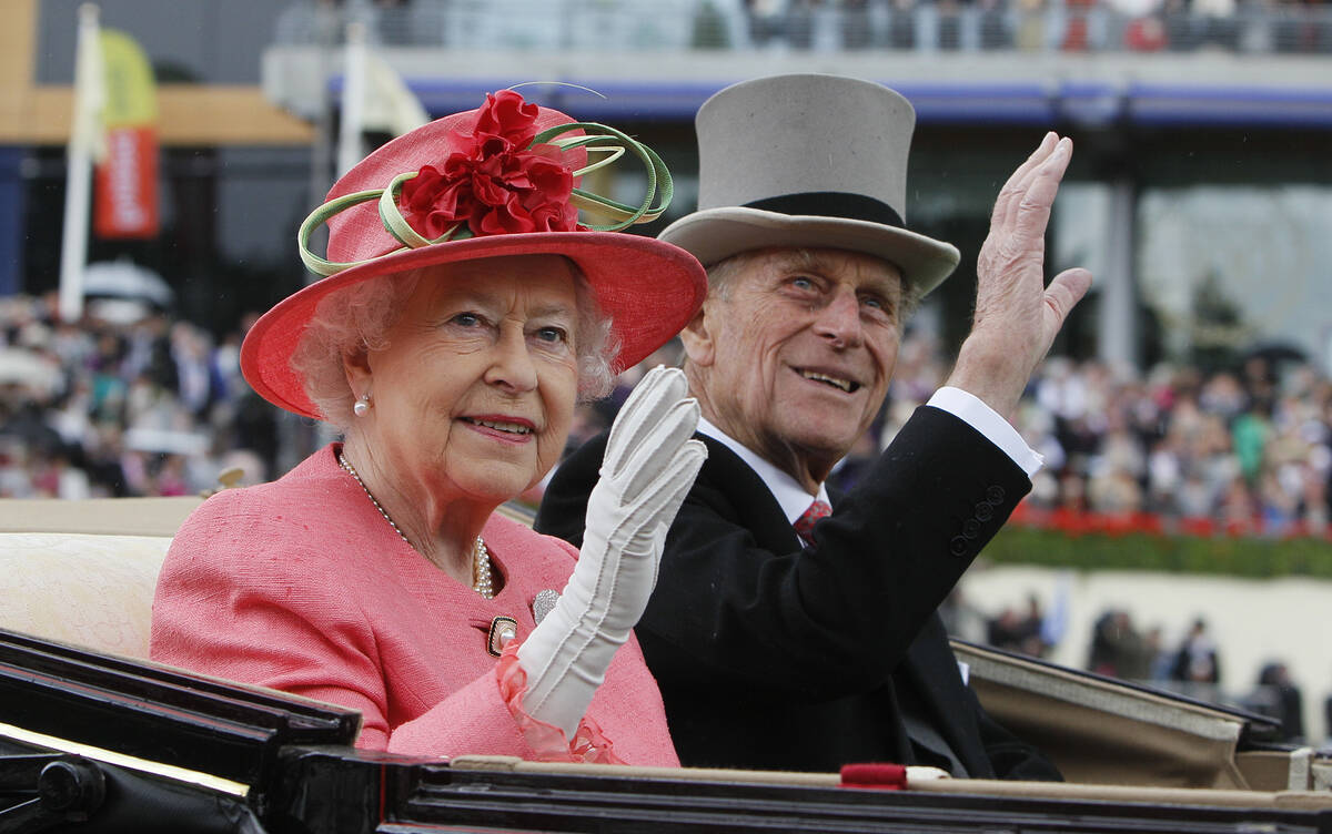 Britain's Queen Elizabeth II with Prince Philip arrive by horse drawn carriage in the parade ri ...