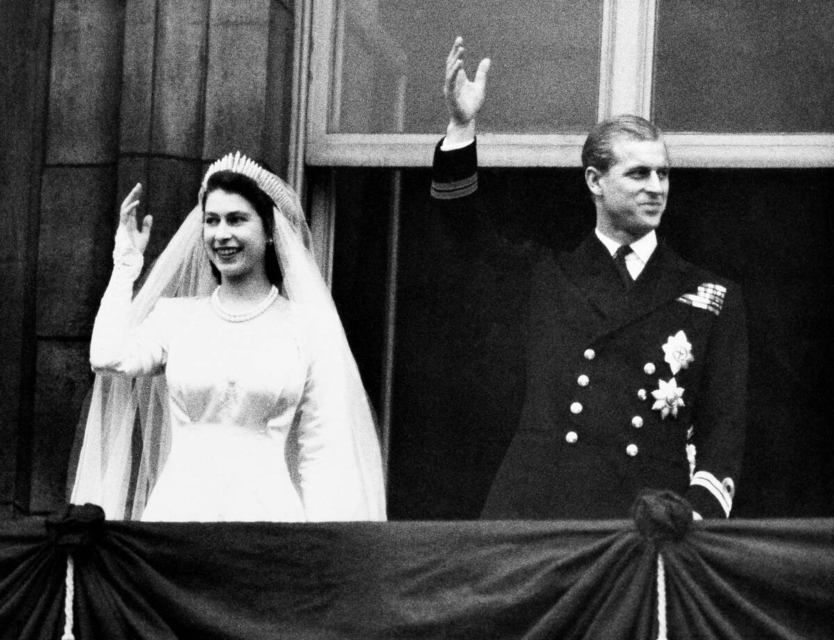 Princess Elizabeth and Prince Philip, Duke of Edinburgh make a charming picture as they wave t ...